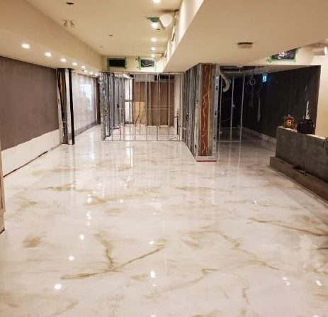 Glossy marble-effect epoxy flooring in a modern commercial space in Cambridge.