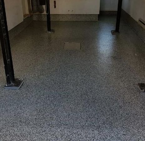 Industrial-style garage in Cambridge featuring a newly applied grey flake epoxy floor coating.