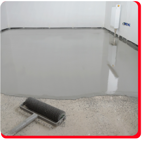 Freshly poured grey epoxy floor with a textured roller on bare concrete in a Markham interior.