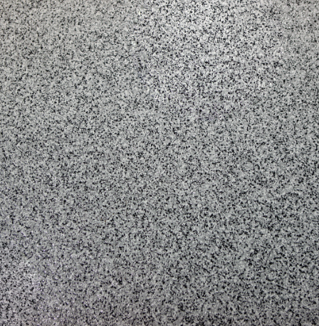 Close-up of a grey flake epoxy flooring texture commonly used in Muskoka garages and workshops.