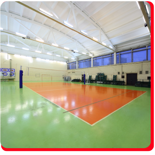 Indoor volleyball court in Vaughan with green and orange epoxy flooring.