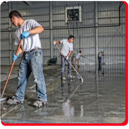 Team applying industrial-grade epoxy flooring in a Vaughan warehouse facility.