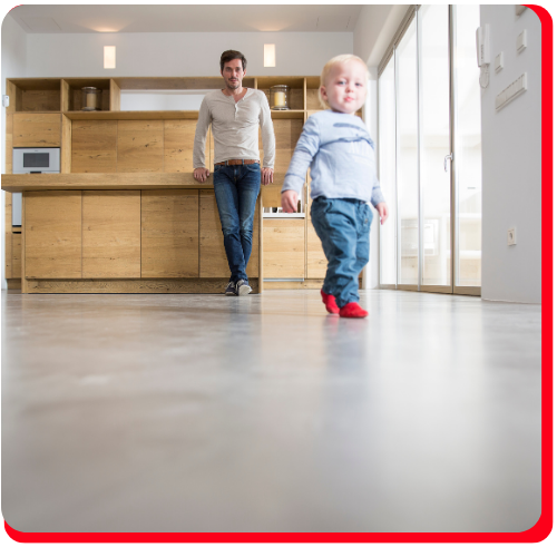 Father and toddler enjoying a clean, durable epoxy-coated floor in a modern residential kitchen.