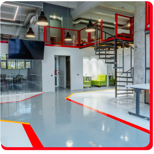 Worker in Aurora applying waterproof epoxy floor coating with a spreader.