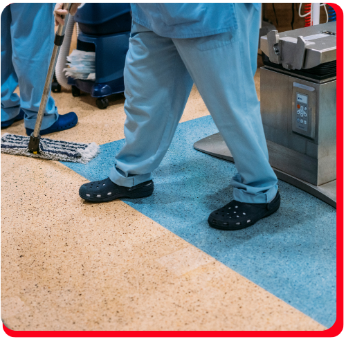 Technicians in Aurora applying seamless waterproof floor coating with rollers.
