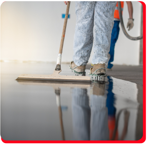 Worker applying a smooth waterproof epoxy floor coating in a Toronto facility.