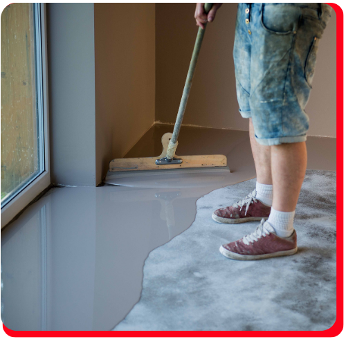 Worker applying waterproof epoxy floor coating in a residential Toronto home.