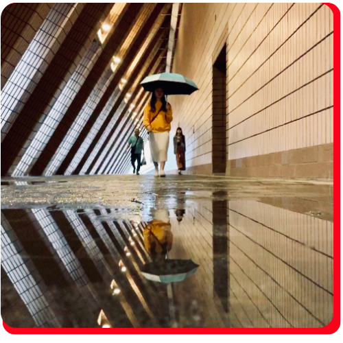 A woman walks on a reflective waterproof floor coating in a modern Toronto walkway.