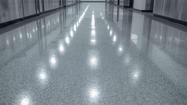 High gloss speckled epoxy floor in a commercial hallway with reflected lighting